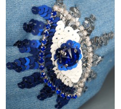 Headband with embroidery eyes. Light blue jeans